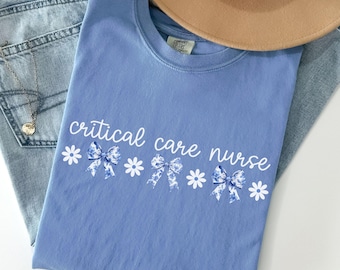 Camiseta de enfermera de cuidados críticos, Comfort Colors®, unidad de cuidados intensivos, camiseta de enfermera de cuidados intensivos, UCI de emergencia, equipo, camiseta, coqueta, lazo, flores, femenina, regalo