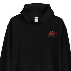 May include: Black hooded sweatshirt with a red and green logo that says "Red Apple Cigarettes" on the left chest.