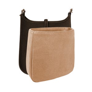 May include: A brown leather bag with a beige felt liner. The bag has a long strap and a flap closure.