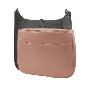 May include: A gray leather handbag with a pink fabric insert. The insert has two pockets.