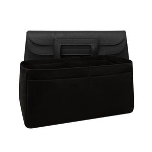 May include: A black handbag with a structured design and a matching black felt organiser insert. The handbag features a top handle and a flap closure. The organiser has multiple compartments for storage.