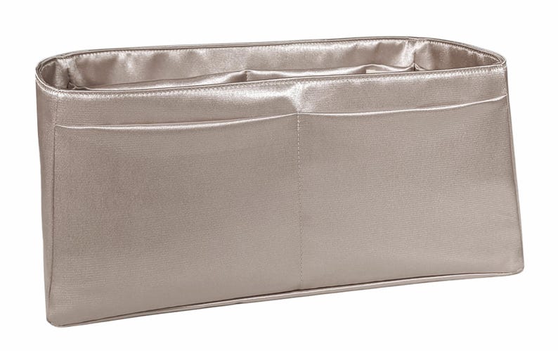 Puede incluir: Organizador de bolso rectangular plateado met&aacute;lico con dos bolsillos delanteros. El interior y el exterior est&aacute;n hechos de un material brillante, similar al sat&eacute;n. El bolso est&aacute; dise&ntilde;ado para caber dentro de un bolso tote o de mano m&aacute;s grande.