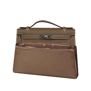 May include: A taupe handbag organiser insert placed in front of a taupe leather handbag. The handbag features a top handle, a flap closure with a metallic turn-lock mechanism, and white contrast stitching along the edges and straps.