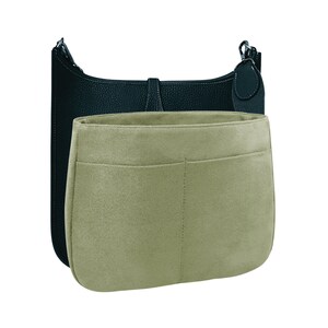 May include: A black leather handbag with a beige felt insert. The insert has two pockets.