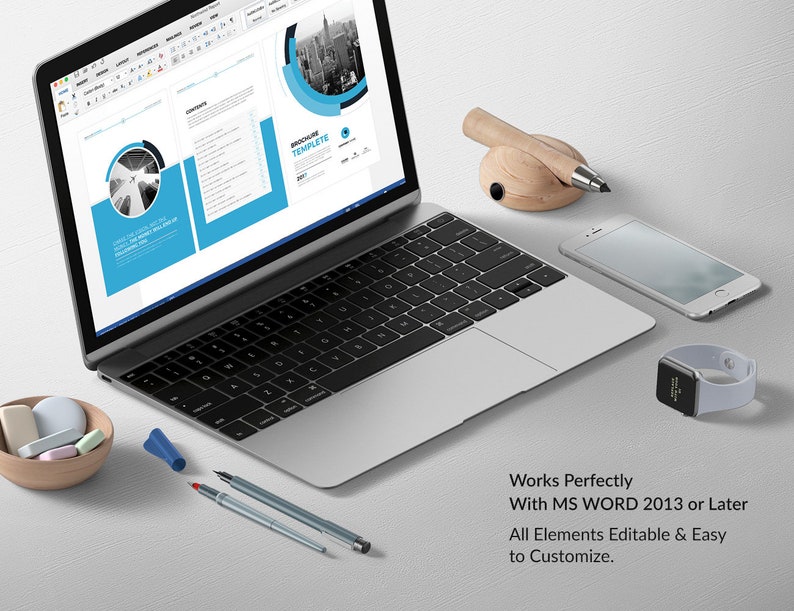 May include: A laptop computer displaying a Microsoft Word document with a brochure template. The document has a blue and gray color scheme and features a cityscape graphic. The text "Brochure Template" is visible on the document. The laptop is on a white surface with a pencil holder, a smartphone, and a smartwatch.