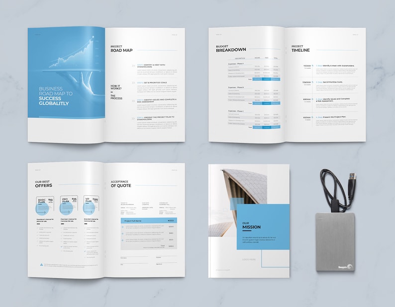 May include: A brochure with a blue and white color scheme. The brochure is open to show the different sections, including a business road map, budget breakdown, project timeline, our best offers, acceptance of quote, and our mission. The brochure is on a white surface with a silver external hard drive and a black cable.