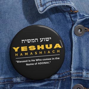 May include: A black button with yellow text that reads "ישוע המשיח YESHUA HAMASHIACH" and "Blessed is He Who comes in the Name of ADONAI."