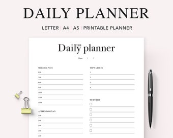 May include: A printable daily planner with sections for morning and afternoon plans, top targets, and a to-do list. The planner has a simple black and white design.