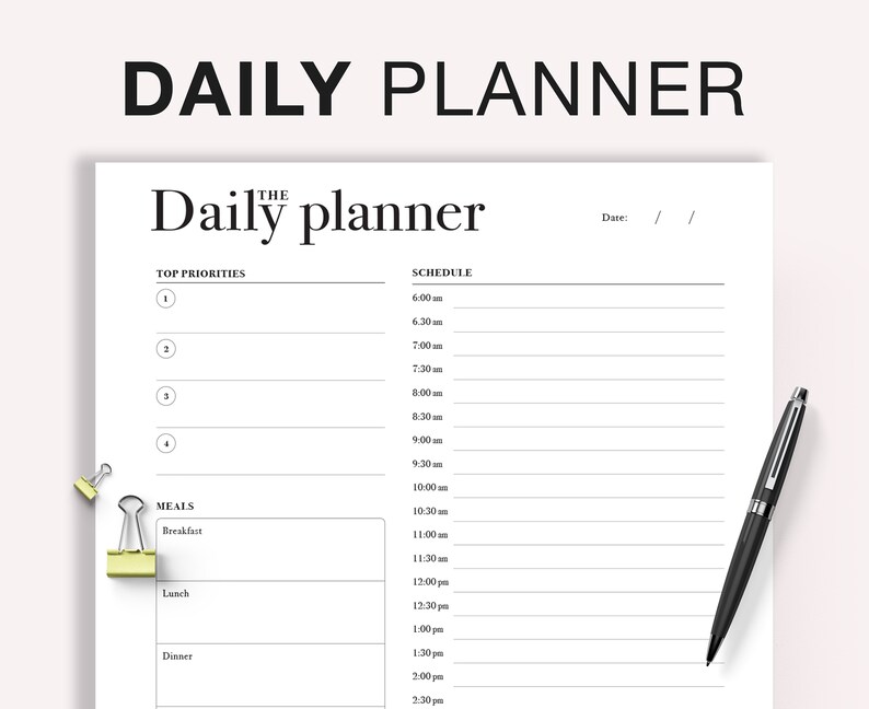 May include: A black and white daily planner with the text "Daily planner" at the top. The planner has sections for top priorities, schedule, and meals. The schedule section includes time slots from 6:00 am to 2:30 pm. The meals section includes breakfast, lunch, and dinner.