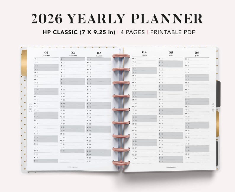 May include: An open 2026 yearly planner with a white interior and grey and white grid layouts for each month. The planner is labeled "HP CLASSIC (17.78 x 23.5 cm)" and includes the text "2026 YEARLY PLANNER". The planner is bound with a rose gold coil.