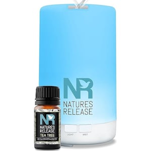 May include: A light blue cylindrical essential oil diffuser with a white base and two buttons labeled Light and Mist, featuring the Natures Release logo. Beside it is a small brown glass bottle of Tea Tree essential oil, 0.33 fl oz (10ml).