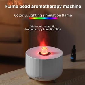 May include: A white cylindrical aromatherapy machine with a textured exterior and small feet. The top features a glowing orange orb emitting a flame-like mist effect. Text reads: Flame bead aromatherapy machine, Colorful lighting simulation flame.