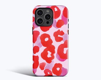 May include: A smartphone case featuring a light pink background with a repeating pattern of abstract, watercolor-style shapes in vibrant red and soft purple. The case has a cutout for a triple-lens camera system on the upper left side.
