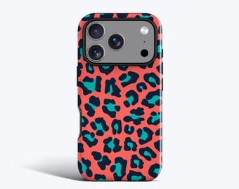 May include: A smartphone case featuring a vibrant coral background with a repeating leopard print pattern in dark navy blue and bright teal. The case includes a rectangular cutout at the top for the camera lenses and flash, showing the phone's back.