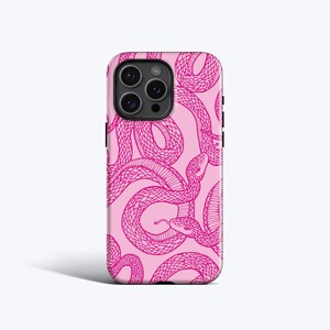 May include: A smartphone case featuring a repeating pattern of dark pink snakes on a light pink background. The design includes multiple coiled snakes with visible scales and one snake with a visible tongue, covering the entire back of the case.