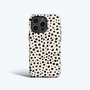May include: A smartphone case featuring a cream-coloured base with a pattern of black spots. The case has cutouts for the camera and buttons. The design is reminiscent of a dalmatian's coat.