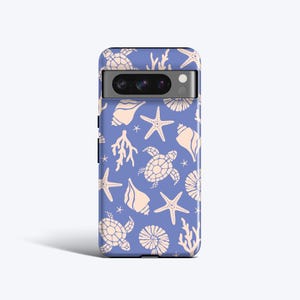 Könnte beinhalten: Eine blaue Handyhülle mit einem Muster aus Muscheln, Seesternen und Meeresschildkröten. Die Hülle hat einen Kameraausschnitt und einen weißen Hintergrund.