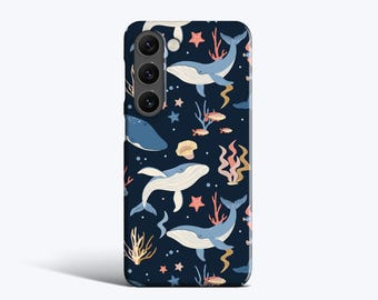 May include: A navy blue phone case featuring a whimsical ocean pattern. The design includes illustrations of whales, starfish, coral, and small fish. The case has a glossy finish and a camera cutout.