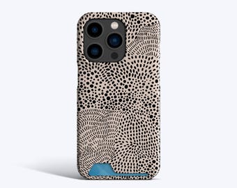 May include: A phone case with a cream-colored background and a black dotted pattern. The design includes areas of small, black dots and curved lines. The case has a blue accent at the bottom and a camera cutout.