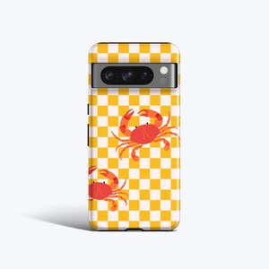 May include: A yellow and white chequered phone case with a red crab design.