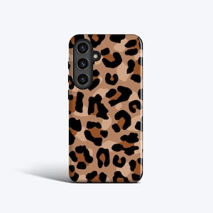 May include: A phone case with a brown and black leopard print design. The case has a camera cutout and a smooth finish. The leopard print pattern is a repeating design of black spots on a tan background.