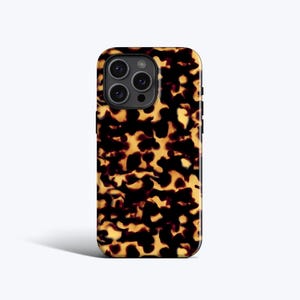 May include: A rectangular smartphone case featuring a dark brown and amber tortoiseshell pattern. The case has a cutout for a triple-lens camera system on the upper left side and covers the back of the device with a glossy, mottled finish.