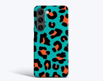 May include: A teal phone case with a black and orange leopard print design. The case has a camera module with three lenses. The leopard spots are in various shapes and sizes, creating a bold and eye-catching pattern.