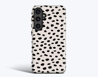 May include: A smartphone case with a cream-colored background and a pattern of black, irregular spots. The case has a camera module with three lenses and a flash. The design is reminiscent of animal print.