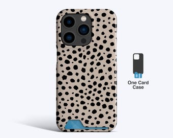 May include: A beige phone case with a black dalmatian spot pattern. The case has a blue card slot at the bottom and a camera cutout at the top. The text "One Card Case" is next to a small illustration of a card case.