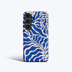 May include: A mobile phone case featuring a blue and beige abstract leaf design. The case has a triple-lens camera cutout on the upper left. The pattern consists of stylized leaves and wavy lines, creating a modern aesthetic.