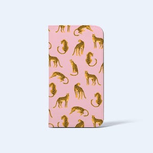 May include: A pink phone case with a repeating pattern of yellow and black spotted cheetahs in different poses. The cheetahs stand out against the pink background. The case is rectangular with rounded corners, suitable for a mobile phone.