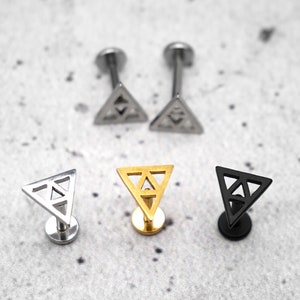May include: Three triangle-shaped earrings with a geometric design. The earrings are made of stainless steel and come in silver, gold, and black.