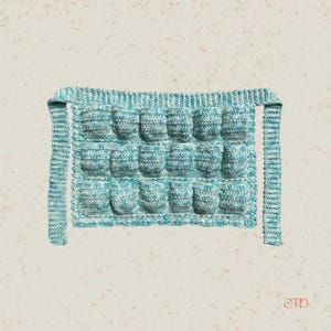 May include: A light blue crocheted dish scrubber with a textured surface. The scrubber has two long straps for hanging.