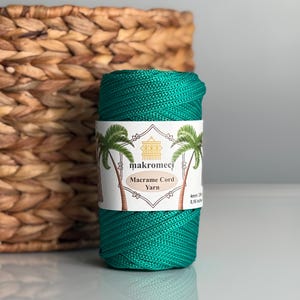 May include: A roll of green macrame cord yarn, 4mm thick, with a label that reads "makromeci Macrame Cord Yarn".