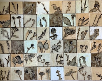 May include: A collection of 36 square ceramic tiles with a botanical theme. Each tile features a different pressed leaf design in shades of brown, beige, and white.