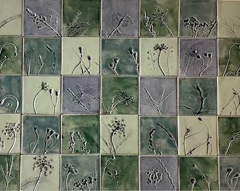 May include: A wall tile set with 36 individual tiles, each featuring a different pressed botanical design. The tiles are a mix of green, gray, and white.