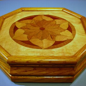 May include: Octagonal wooden tray with a multi-colored wood inlay design in the center. The tray has a raised edge and a base with three tiers.