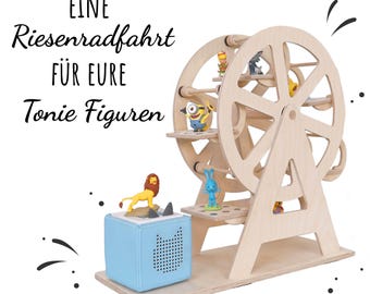 May include: A wooden Ferris wheel toy with character figurines on the platforms. A light blue cube-shaped speaker is in the foreground. The text on the image reads "EINE Riesenradfahrt FÜR EURE Tonie Figuren."