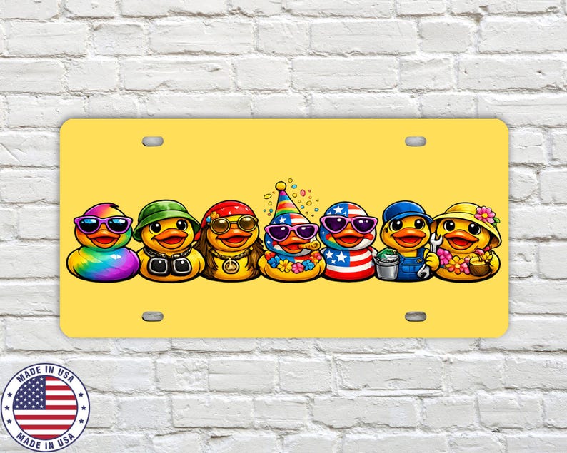 May include: A yellow license plate featuring seven cartoon ducks, each with unique sunglasses and outfits. The ducks are decorated with rainbow, green, red, and blue colors. The license plate has a 'Made in USA' emblem.