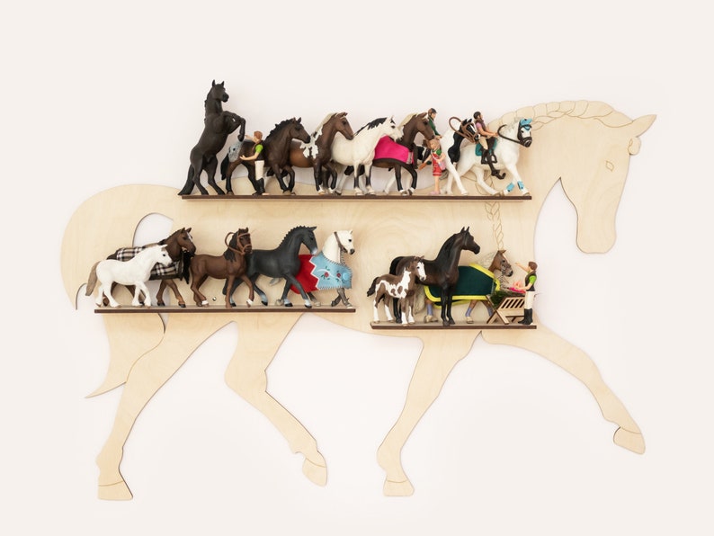 May include: Wooden horse-shaped shelf with two shelves, displaying a collection of miniature horse figurines and people. The figurines are in various poses and colors, including brown, black, white, and gray.