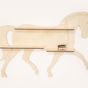 May include: Wooden horse-shaped wall shelf with two shelves. The horse is light brown and has a braided mane.