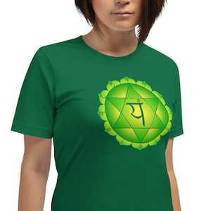 May include: A green t-shirt with a green and yellow chakra symbol and the Sanskrit word "Anahata" printed on the front.