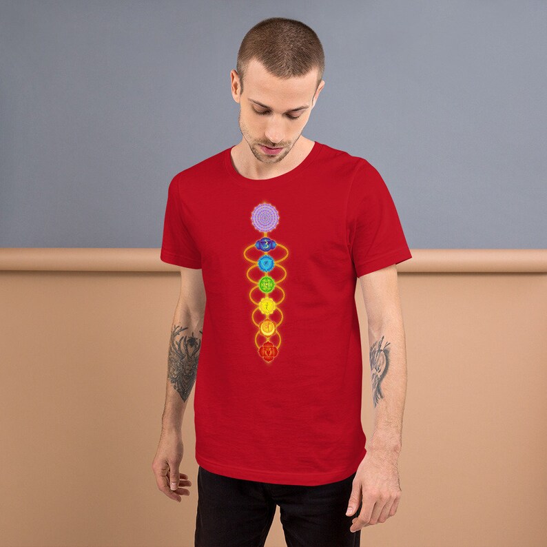 May include: A red t-shirt with a graphic of the seven chakras, a spiritual concept in Hinduism and Buddhism, represented by colorful circles connected by lines.