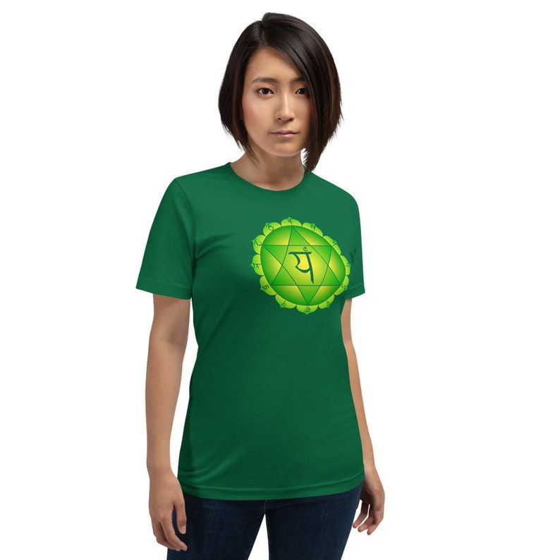 May include: A green t-shirt with a green and yellow chakra symbol and the Sanskrit word "Anahata" printed on the front.
