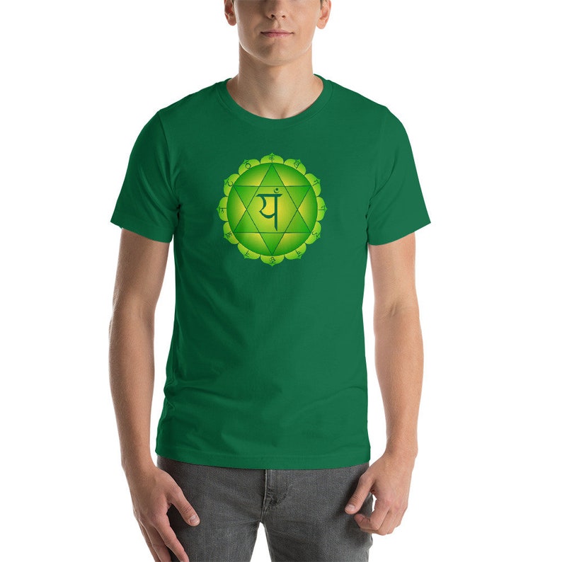 May include: A green t-shirt with a green and yellow chakra symbol and the Sanskrit word "YAH" printed on the front.