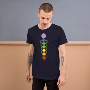 May include: A navy blue t-shirt with a graphic of the seven chakras, a spiritual concept in Hinduism and Buddhism, represented by seven colored circles connected by a golden line.
