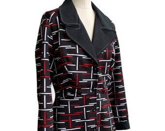 May include: A black, red, and white patterned coat with a black collar and cuffs. The coat features a geometric design of intersecting lines and a double-breasted button closure. The long-sleeved coat is displayed on a mannequin.