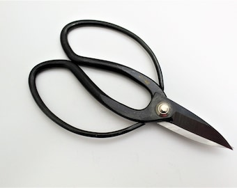 May include: Black pruning shears with a curved handle and a sharp blade. The shears are made of metal and have a silver rivet.