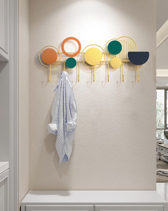 Entryway and Hallway With a Mid Century Modern Wall Mounted Coat Hooks  Rack. Featuring Rustic Gold Coat Hanger Hooks and a Modern Key Holder 