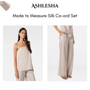 Puede incluir: Conjunto coordinado de seda beige, compuesto por un top sin tirantes y un pantalón de pernera ancha. El conjunto está hecho a medida y se presenta sobre un fondo blanco. La marca "ASHLESHA" y la descripción del producto "Made to Measure Silk Co-ord Set" son visibles.